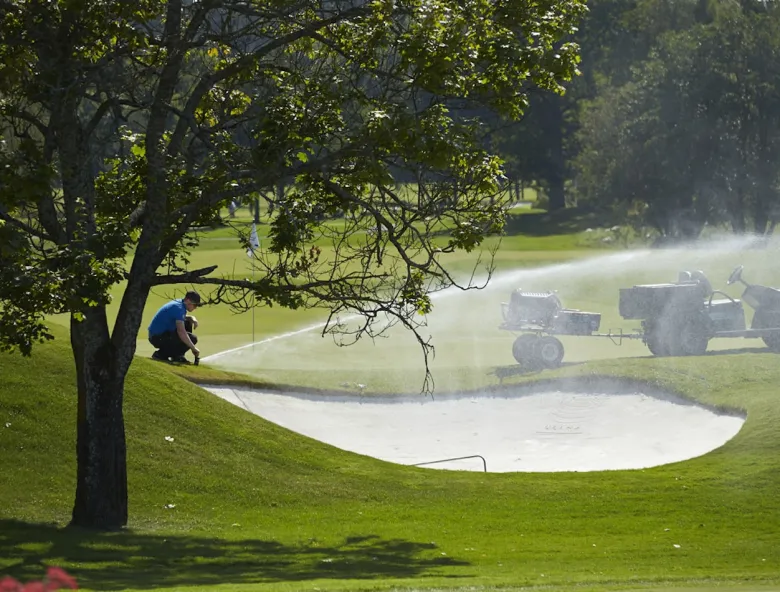 Greenkeeper user sprinkler to irrigate golf course