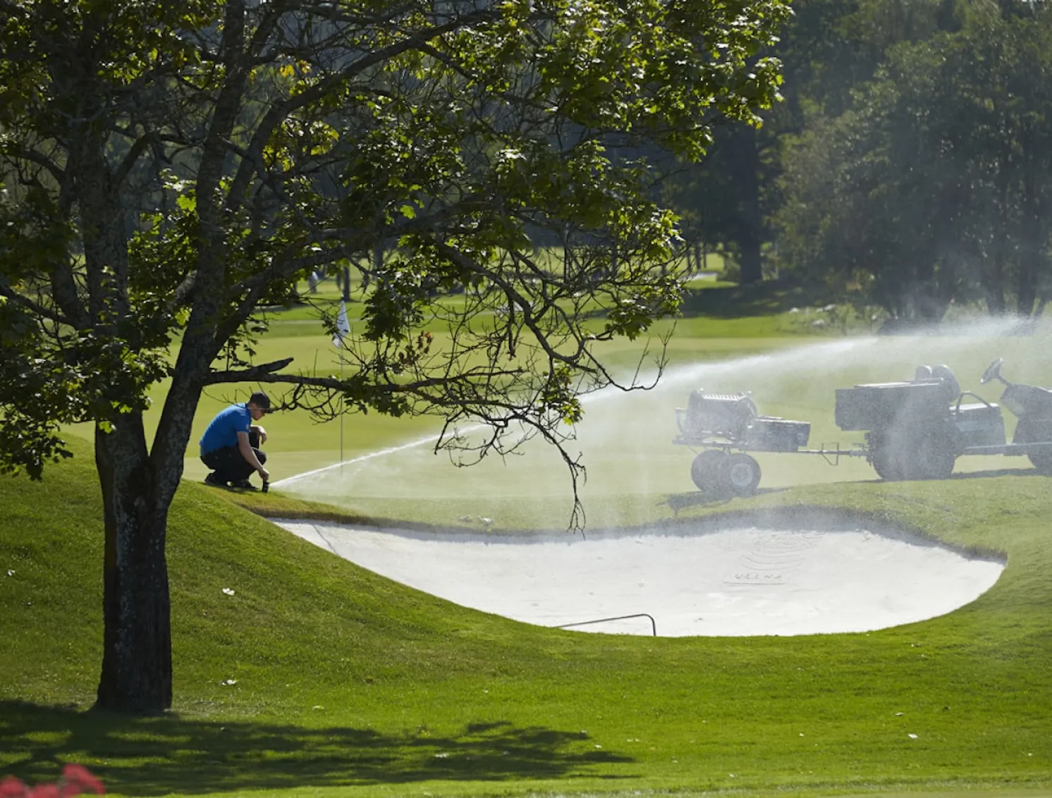 Greenkeeper user sprinkler to irrigate golf course